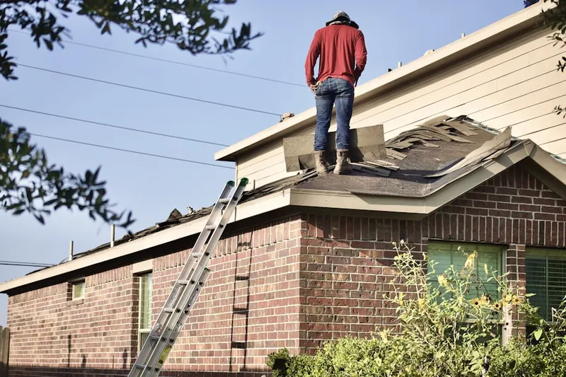 Professional roofer working on a residential roof in Dutch Neck Farms